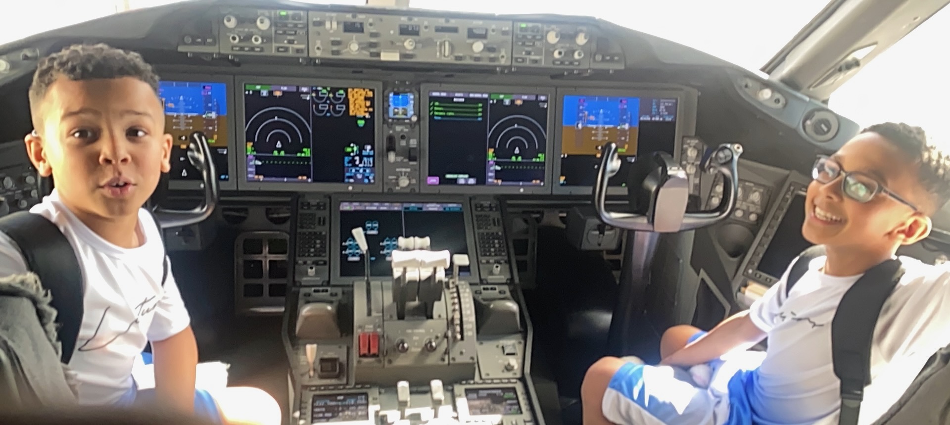 Boys looking at airplane dashboard