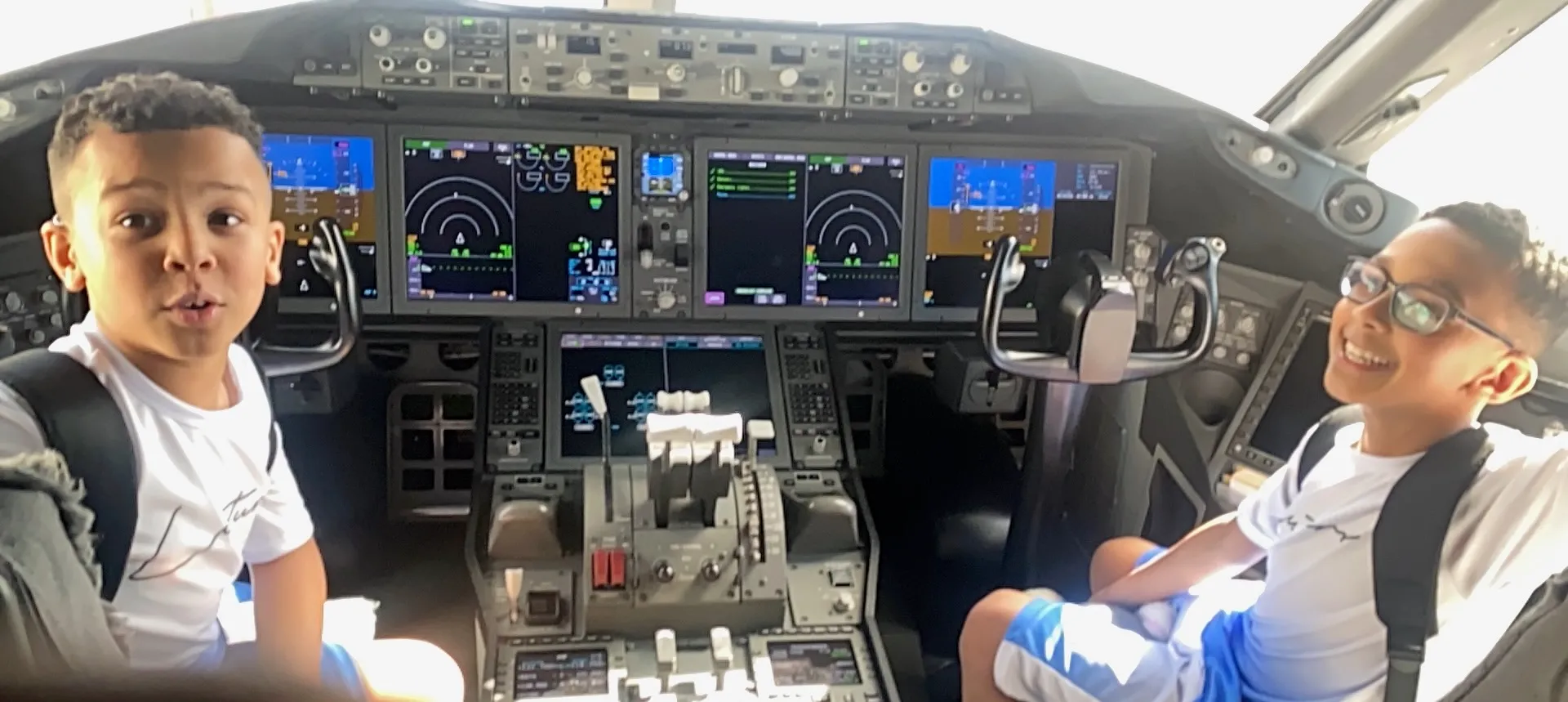 Boys looking at airplane dashboard